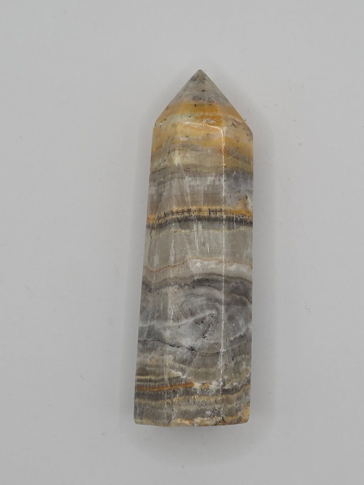 Side view of Bumblebee Jasper tower showing yellow, gray, and black mineral bands. Promotes motivation and balanced energy.