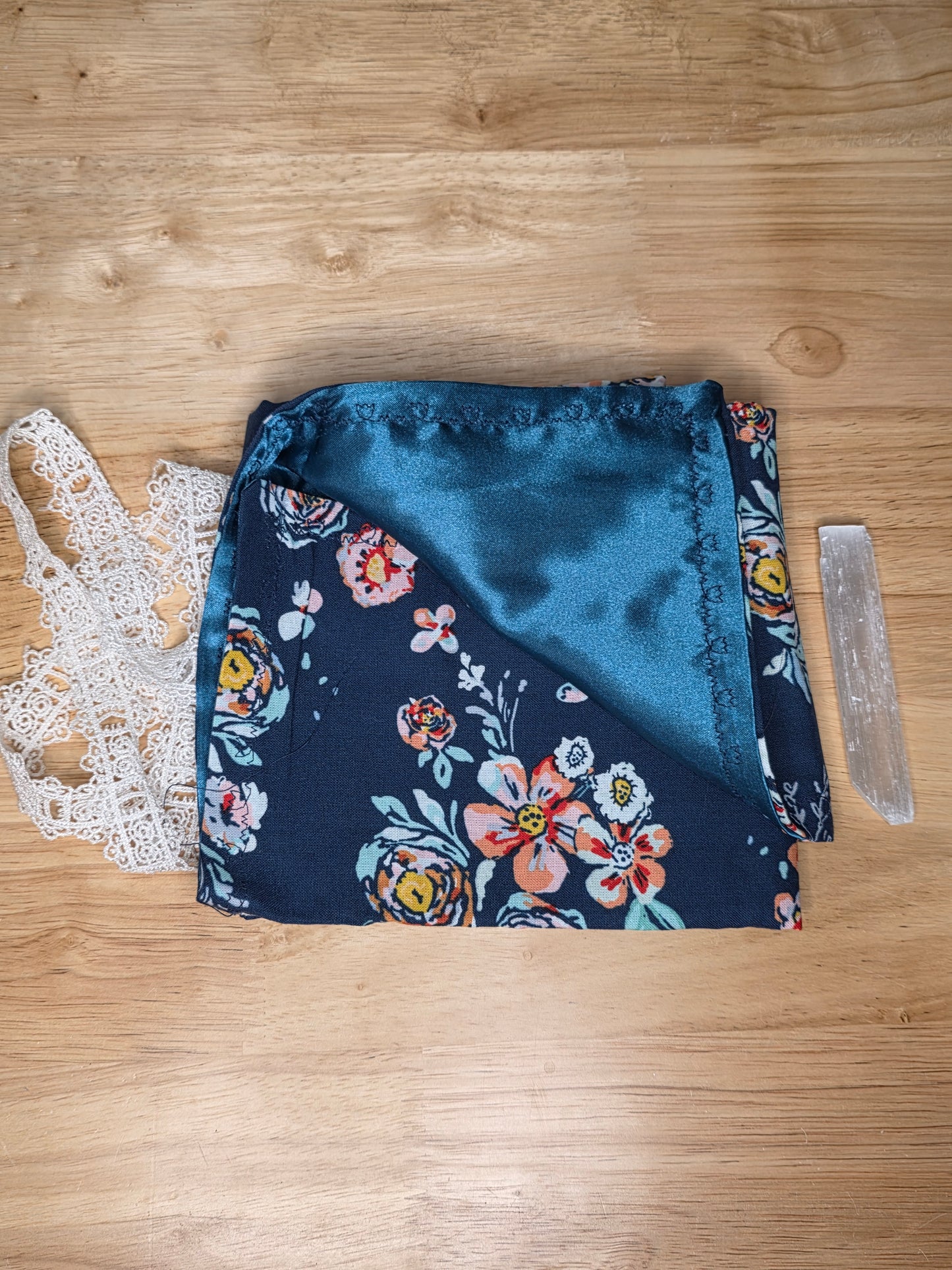 Handmade navy floral tarot wrap with navy satin lining and white lace tie, includes selenite stick.