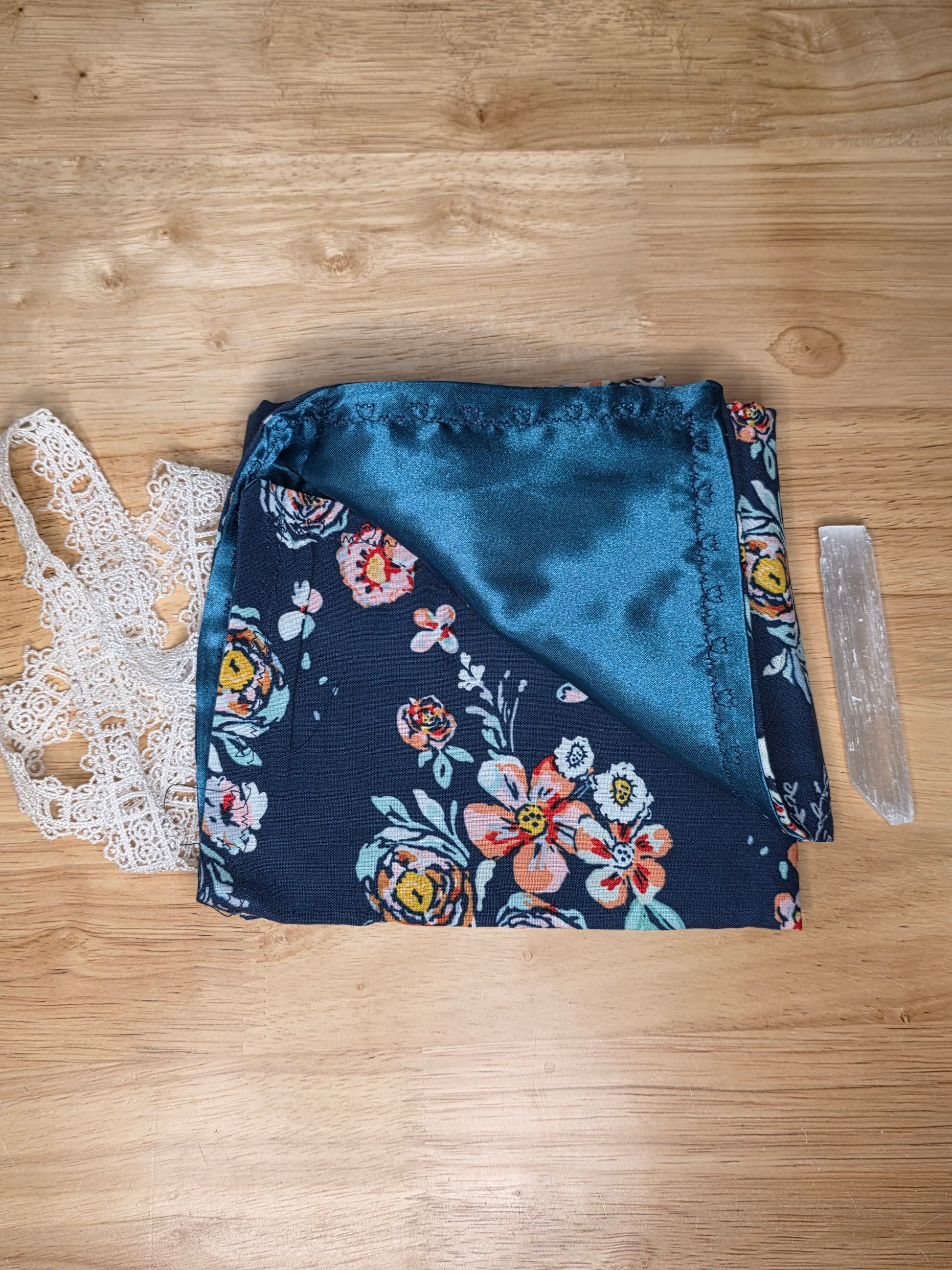 Handmade navy floral tarot wrap with navy satin lining and white lace tie, includes selenite stick.