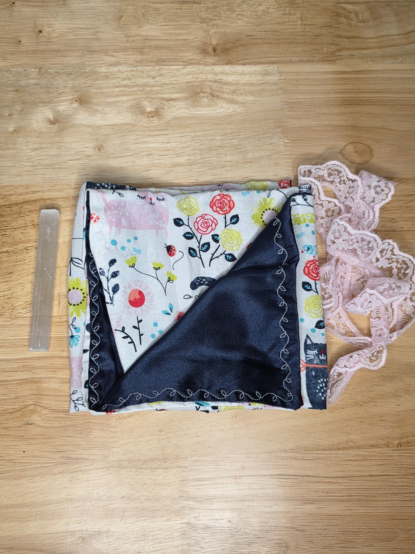 Handmade floral tarot wrap with navy satin lining, pink lace tie, and included selenite stick for cleansing.