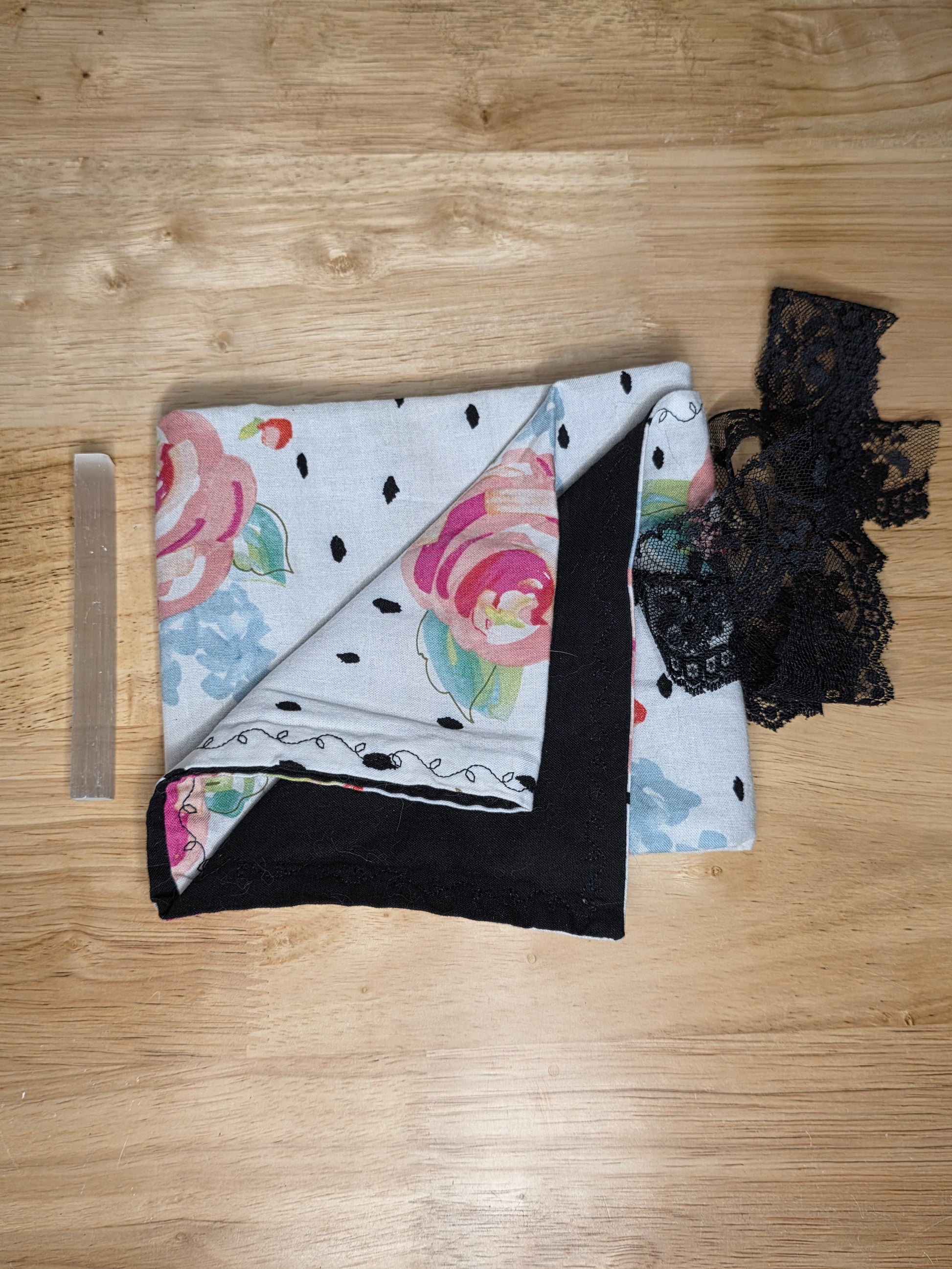 Handmade gray floral tarot wrap with black lining, black lace, and selenite stick for energy cleansing.