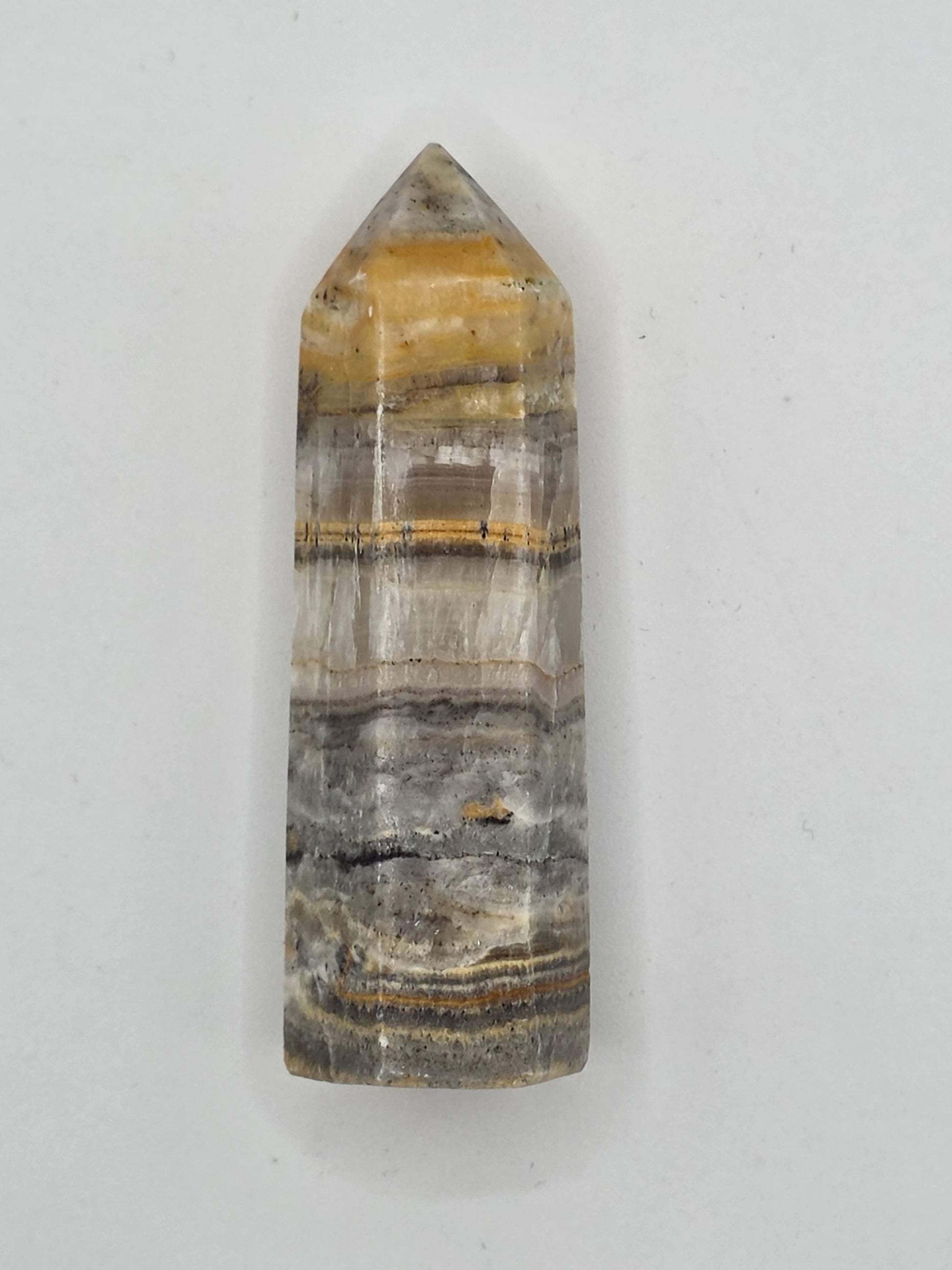 Golden and gray Bumblebee Jasper crystal tower, 2.56 inches tall, with vivid layered bands symbolizing courage and grounding.