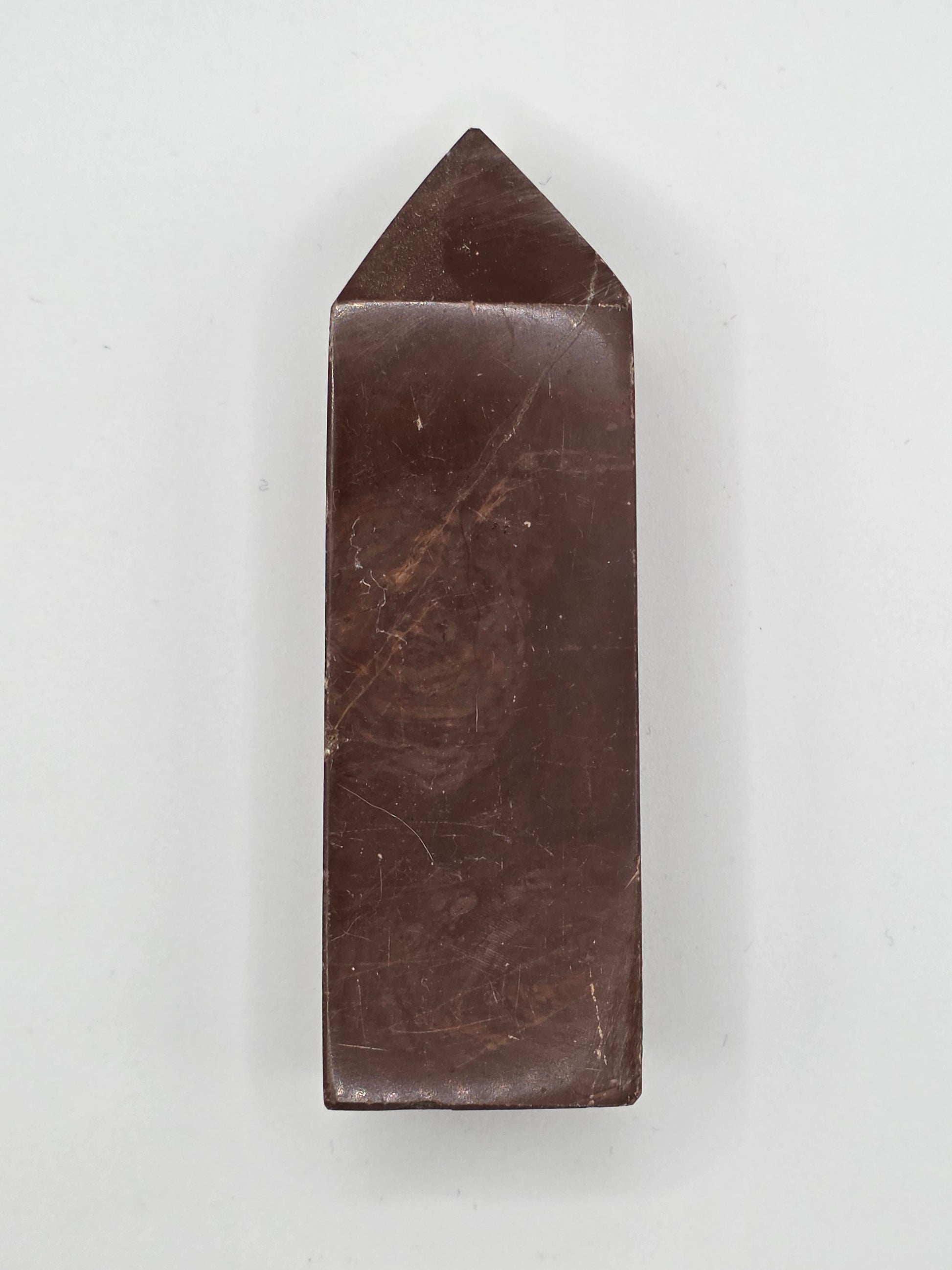 Chocolate Jasper tower with deep brown hue and subtle marbled texture, standing upright on white background.