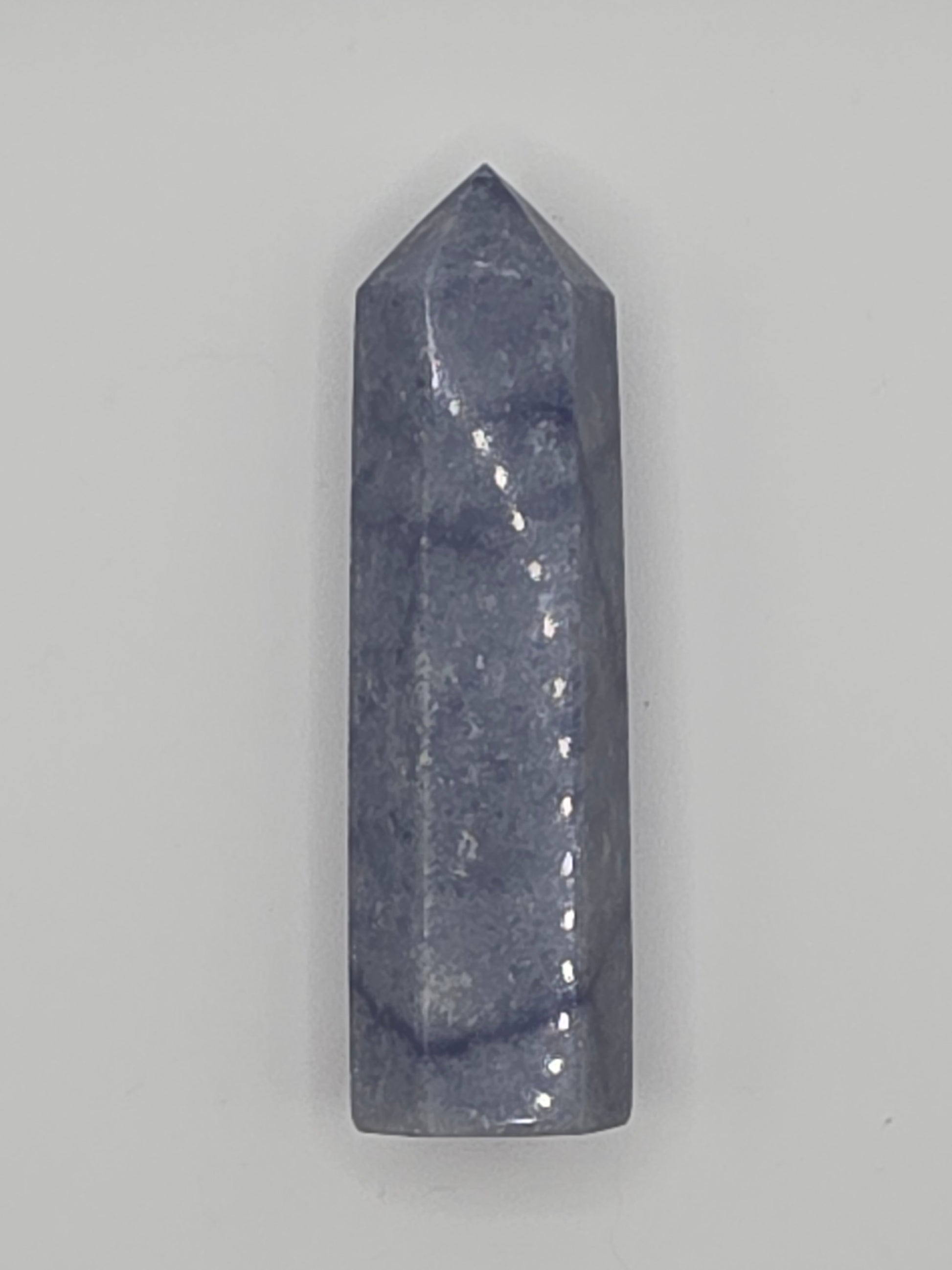 Side view of Dumortierite tower showing denim-blue tones and cloudy patterning. Encourages calm concentration and discipline.