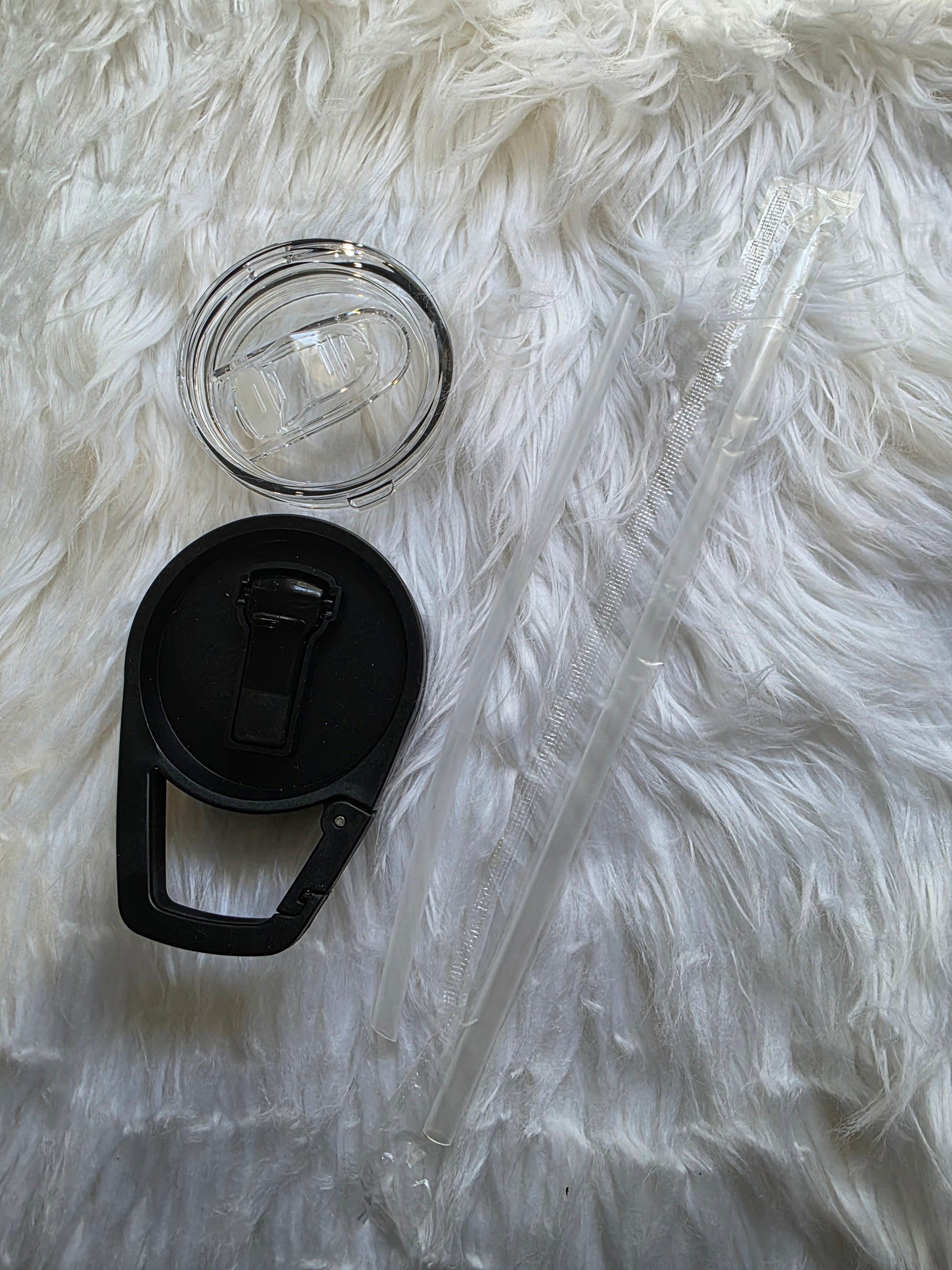 Two tumbler lids shown with reusable straws, including a clear sliding-top lid and a black flip-top sport lid with loop handle