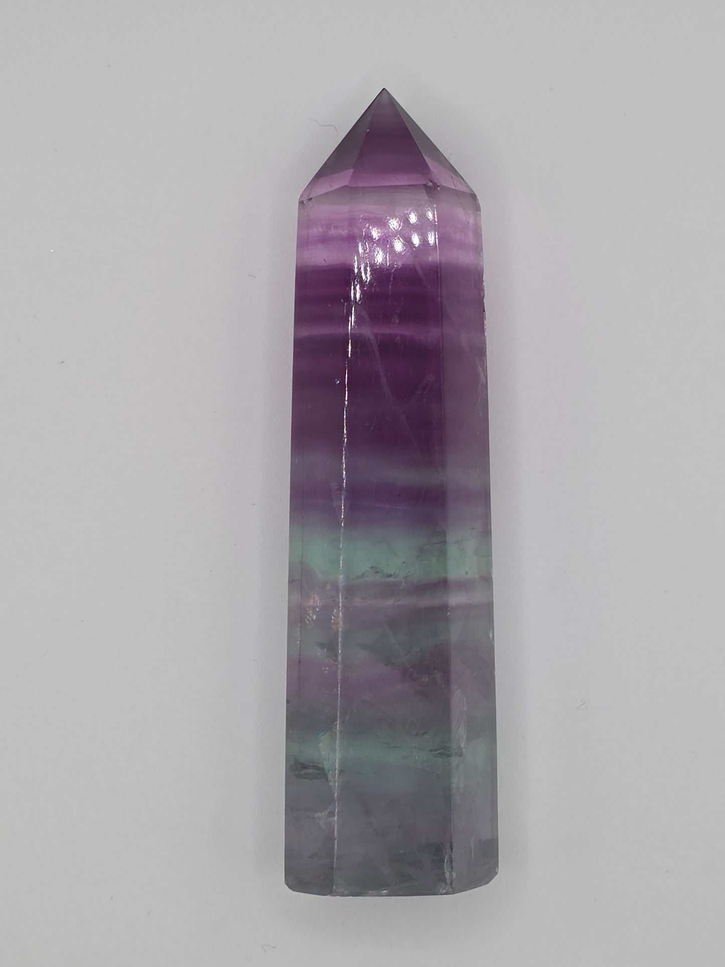 Alternate angle of Fluorite tower showing gradient layers of purple and green.