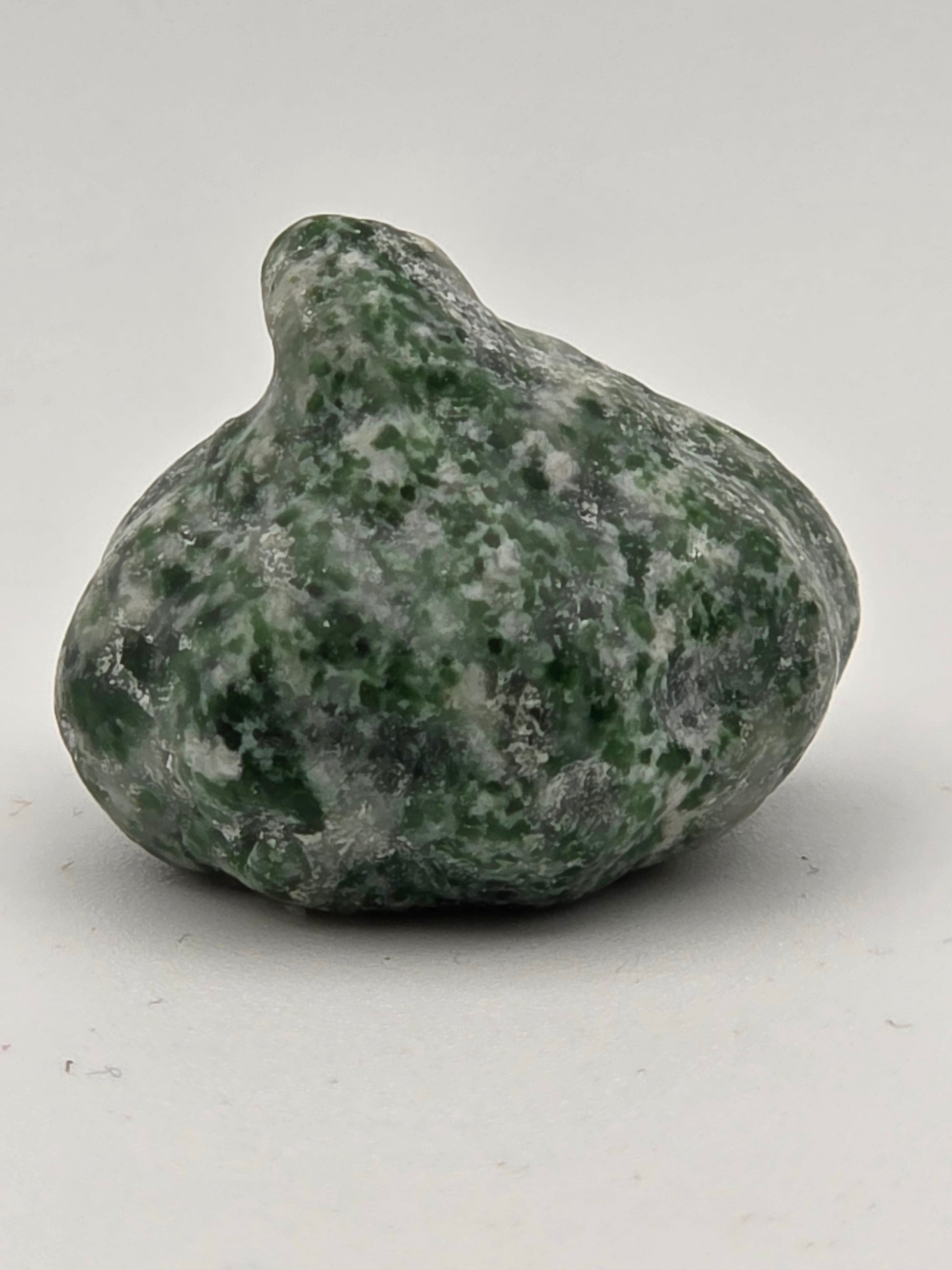 Mini Moss Agate pumpkin on white background showing natural texture and shape.