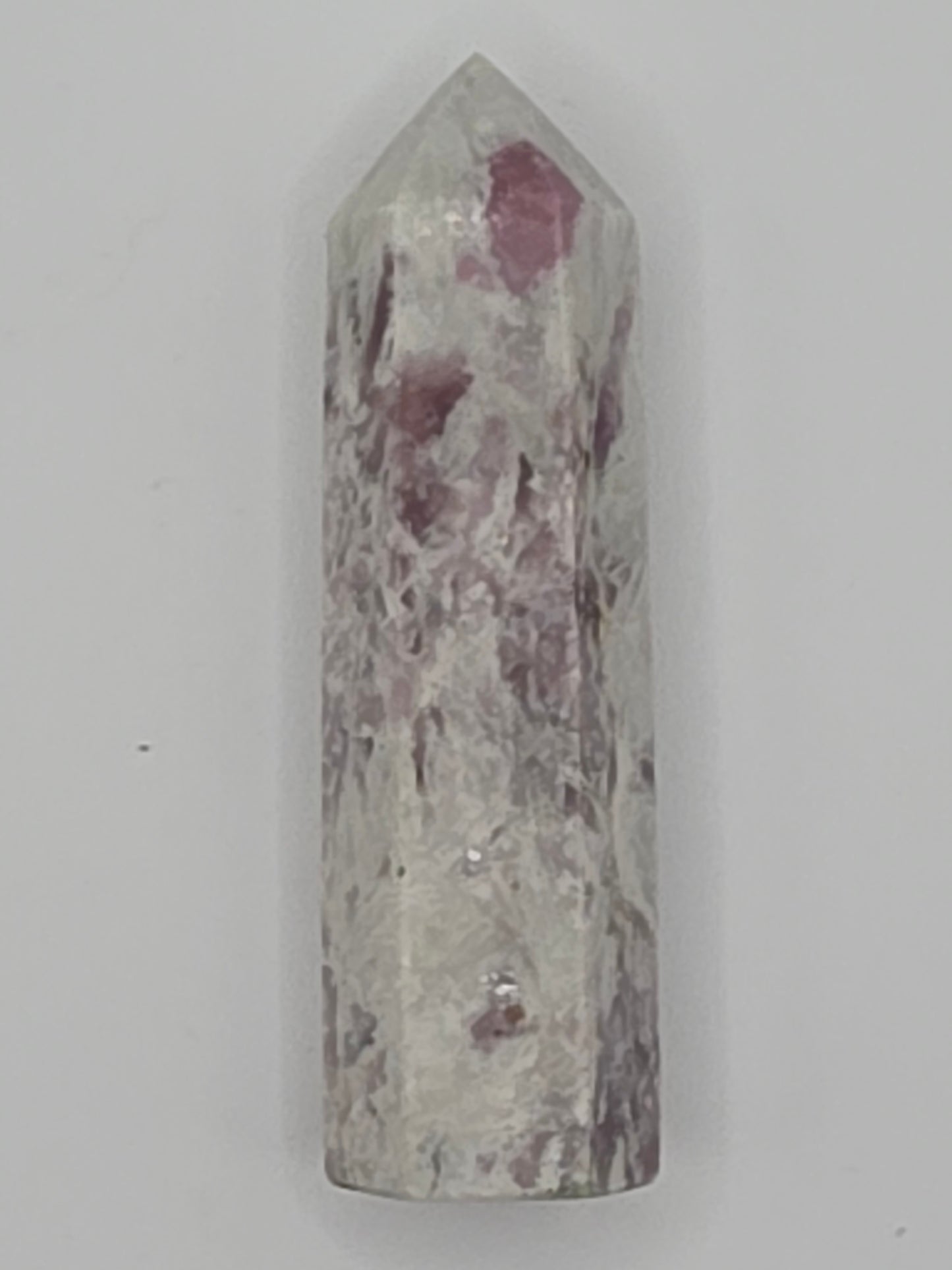 Pink Lepidolite tower with lilac and rose mica shimmer on white background.