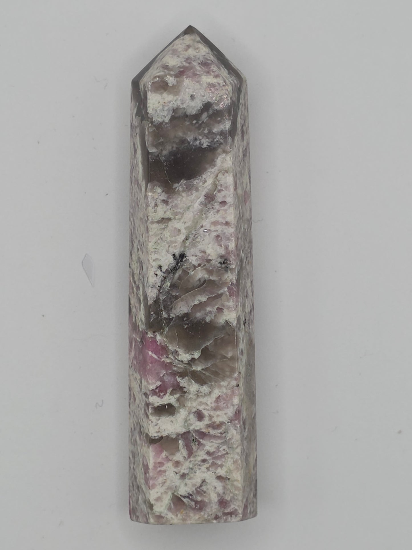 Pink Lepidolite tower with lilac and cream mica layers on white background.