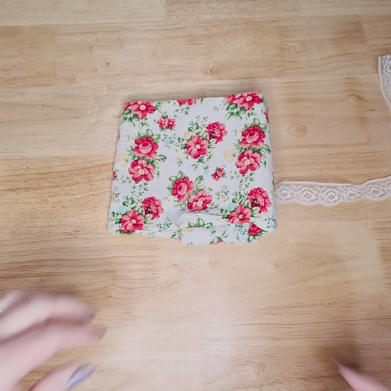 Demonstration video showing how to fold a tarot deck inside a handmade reversible wrap and secure it with the lace tie. Includes tip for storing the selenite stick to keep your deck energetically cleansed.