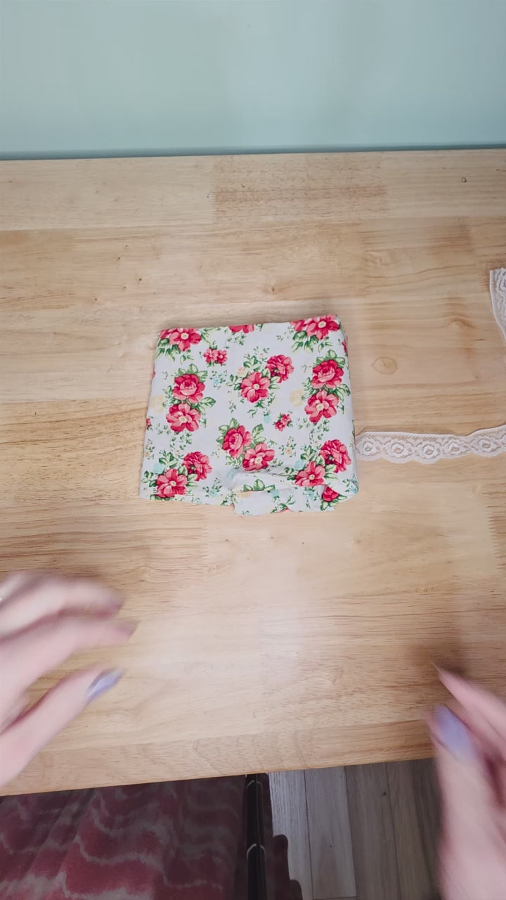 Demonstration video showing how to fold a tarot deck inside a handmade reversible wrap and secure it with the lace tie. Includes tip for storing the selenite stick to keep your deck energetically cleansed.