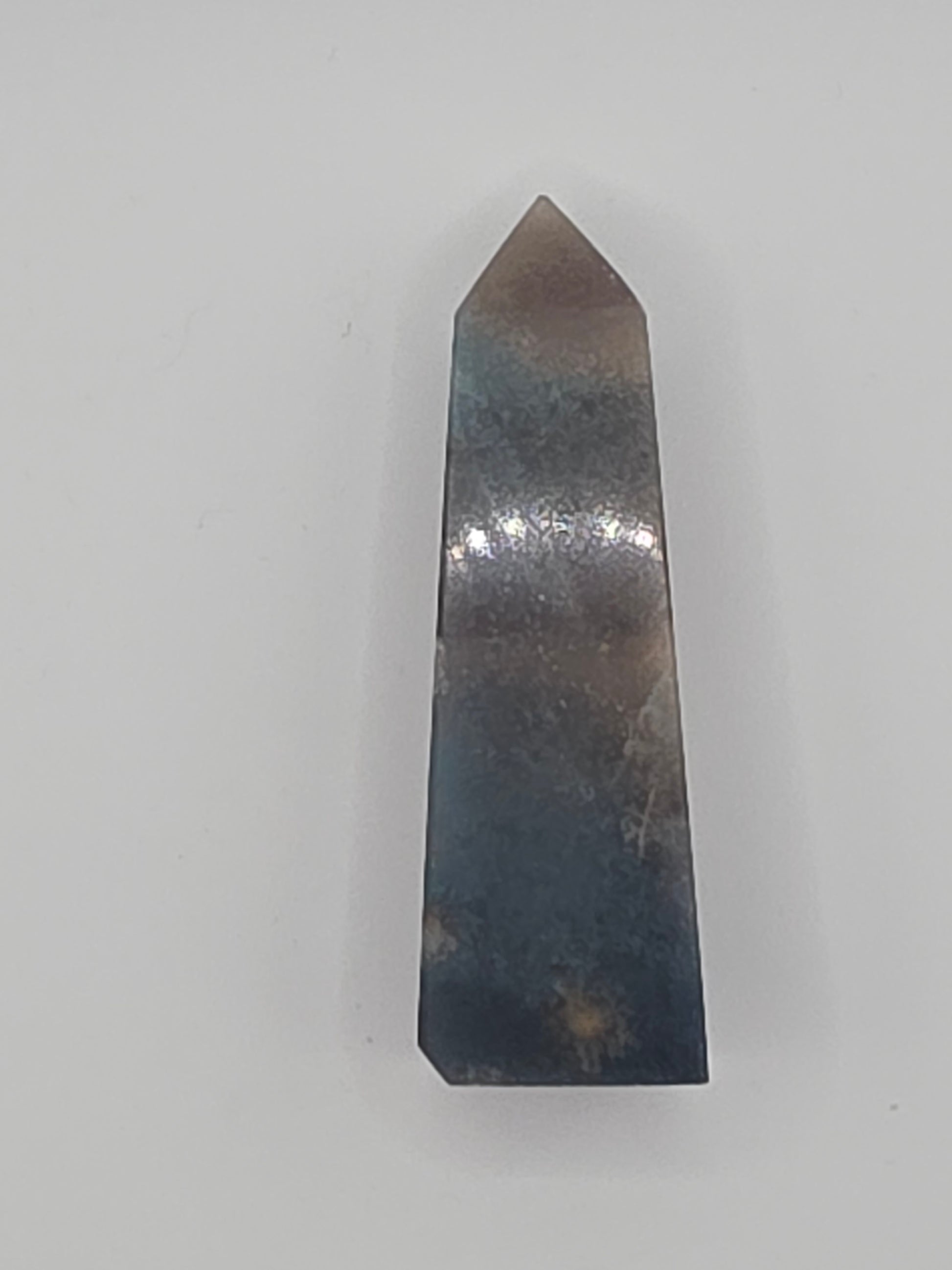 Side angle highlighting subtle blue sheen and organic inclusions.